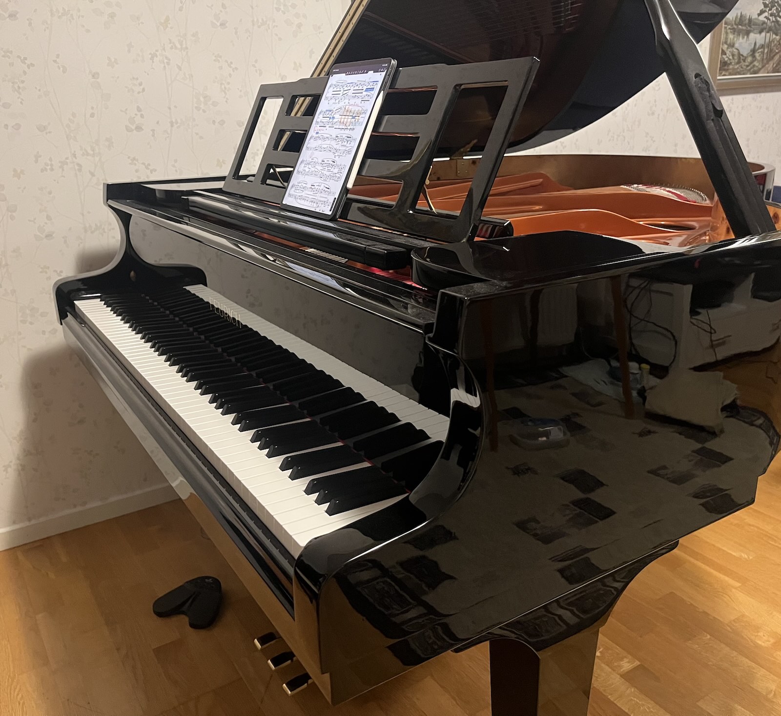 Grand piano with iPad score and page turner